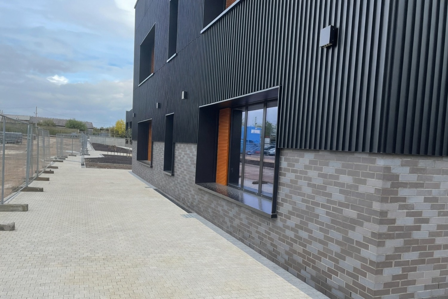 Modern commercial building frontage with finished public-realm paving