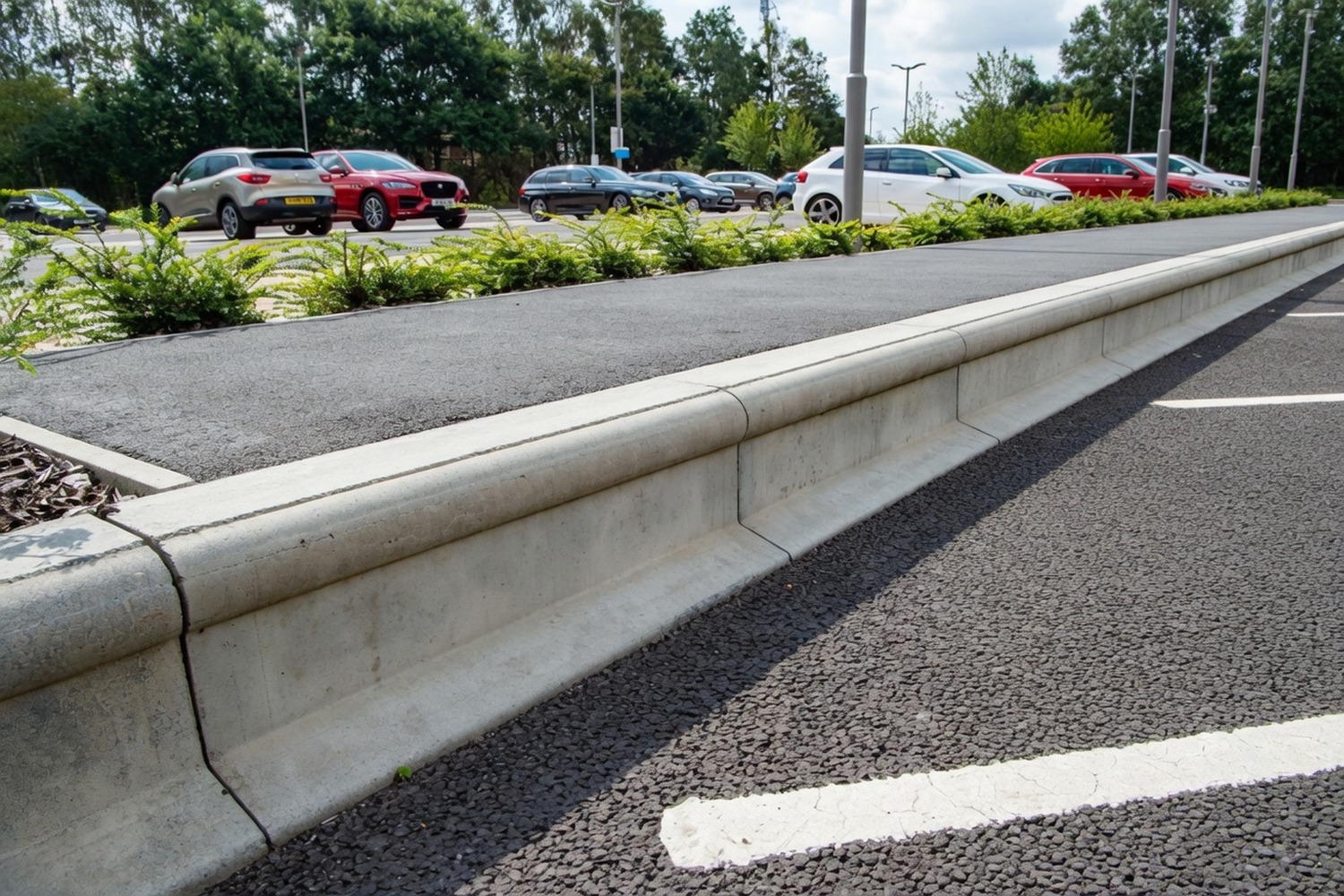 Concrete kerbing along a car-park edge with planted border