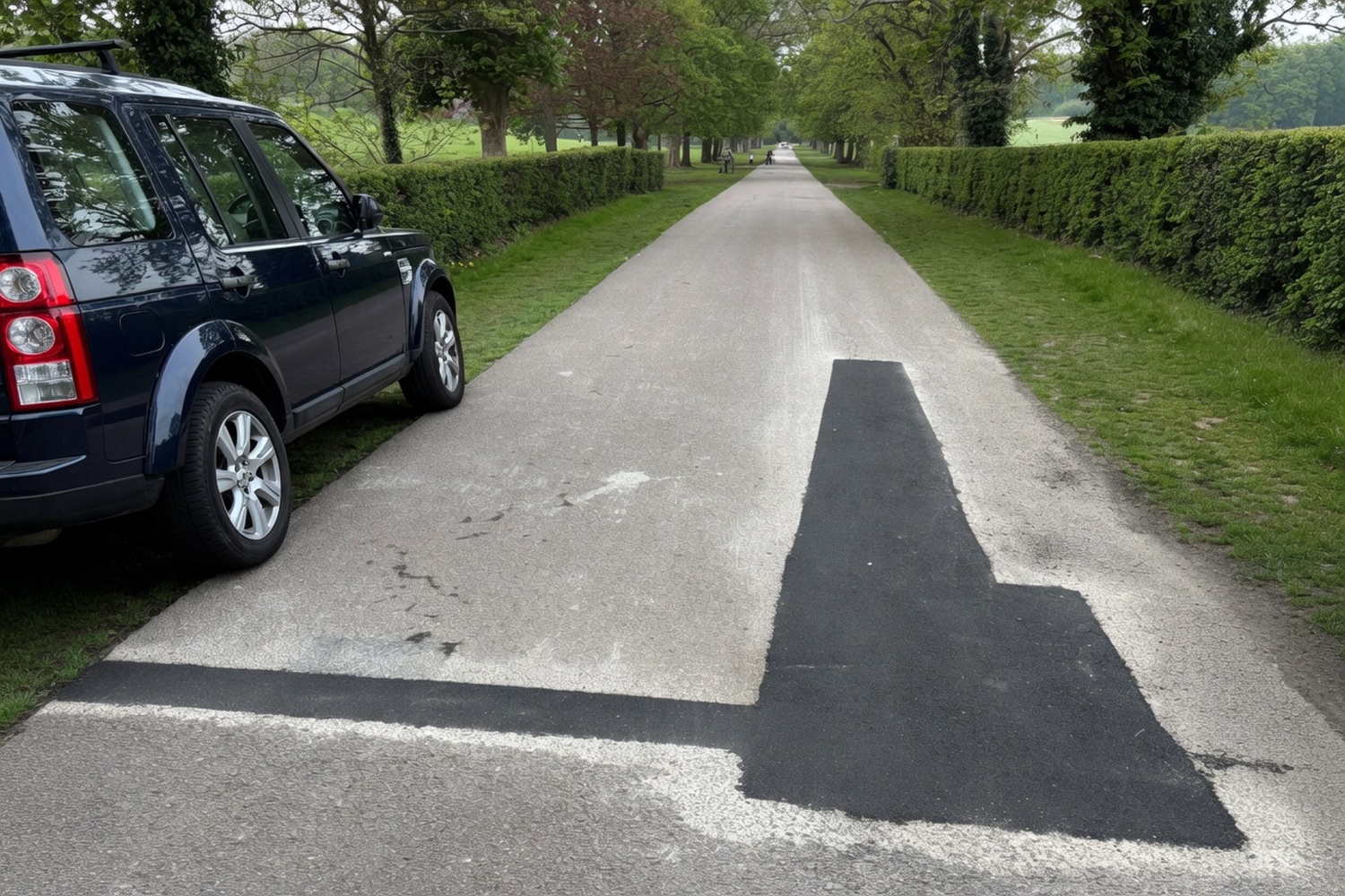 Long fresh asphalt patch on a paved path