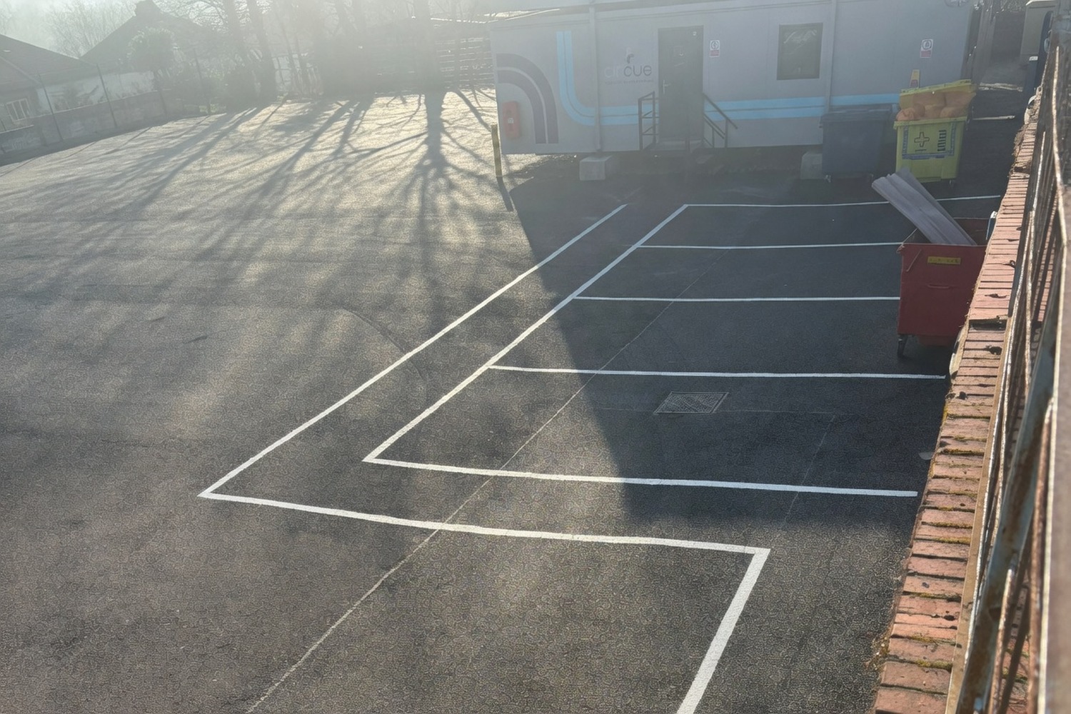 Newly applied SLOW marking on an empty car park access route