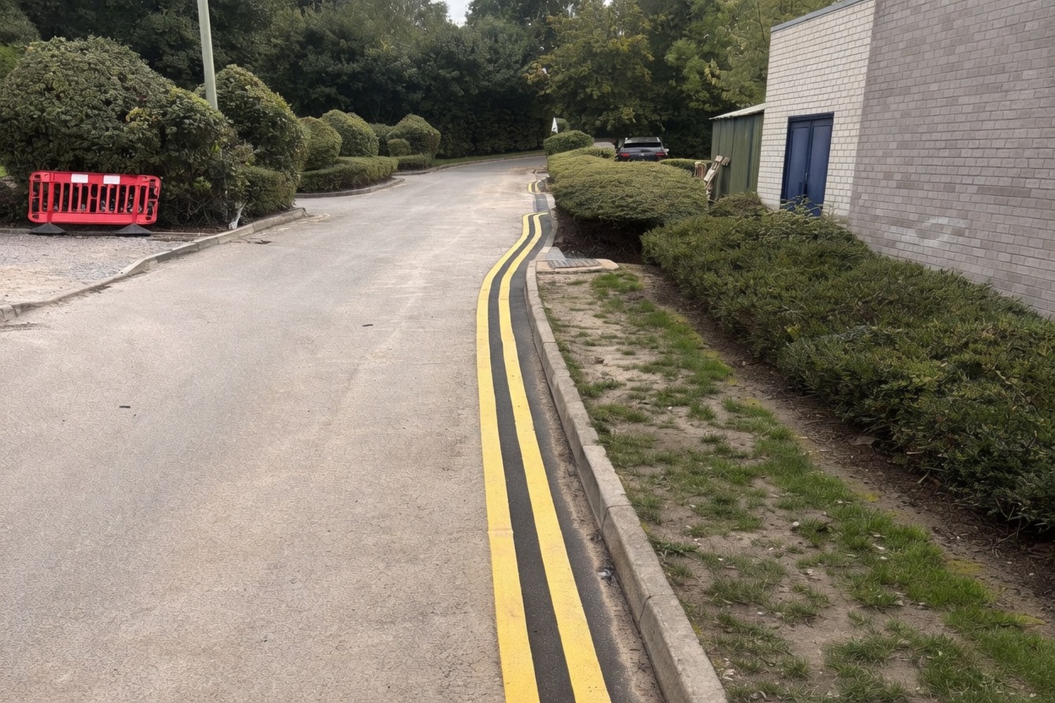 Long stretch of road reinstated with hot-mix tarmac and new thermoplastic double yellow lines